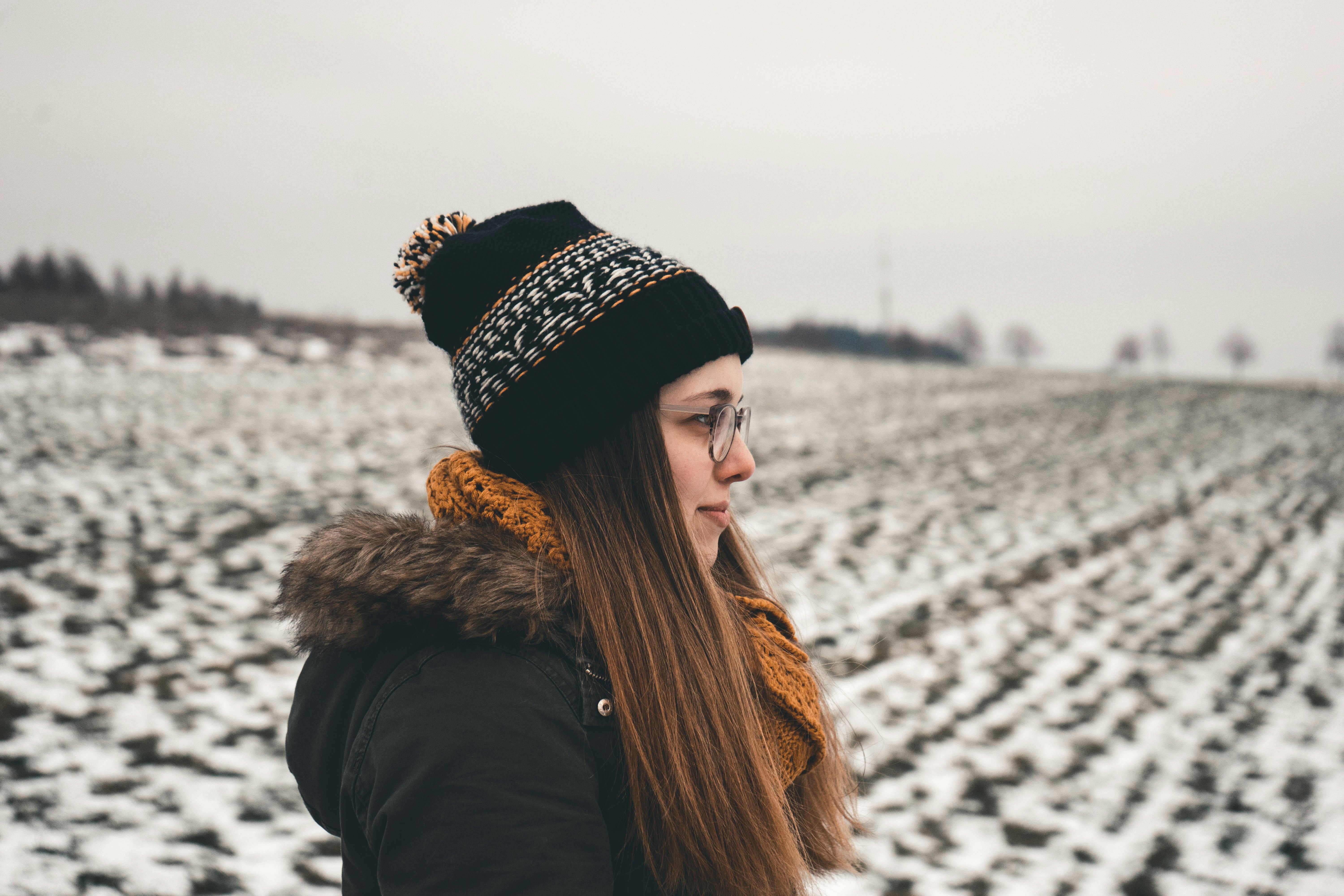 woman standing and smiling looking side